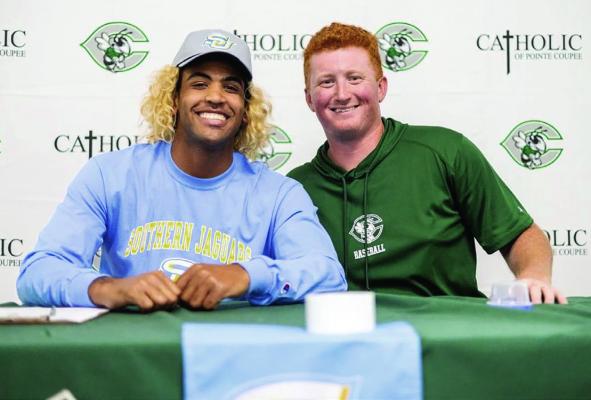 Brant Stewart, of Catholic-PC signs a letter of intent to play baseball at Southern University on April 17. With him is coach Ross Capone. Submitted